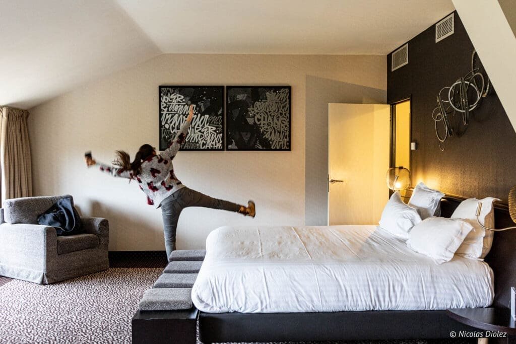 Chambre à l'Hôtel MGallery La Citadelle Metz, femme sautant joyeusement.