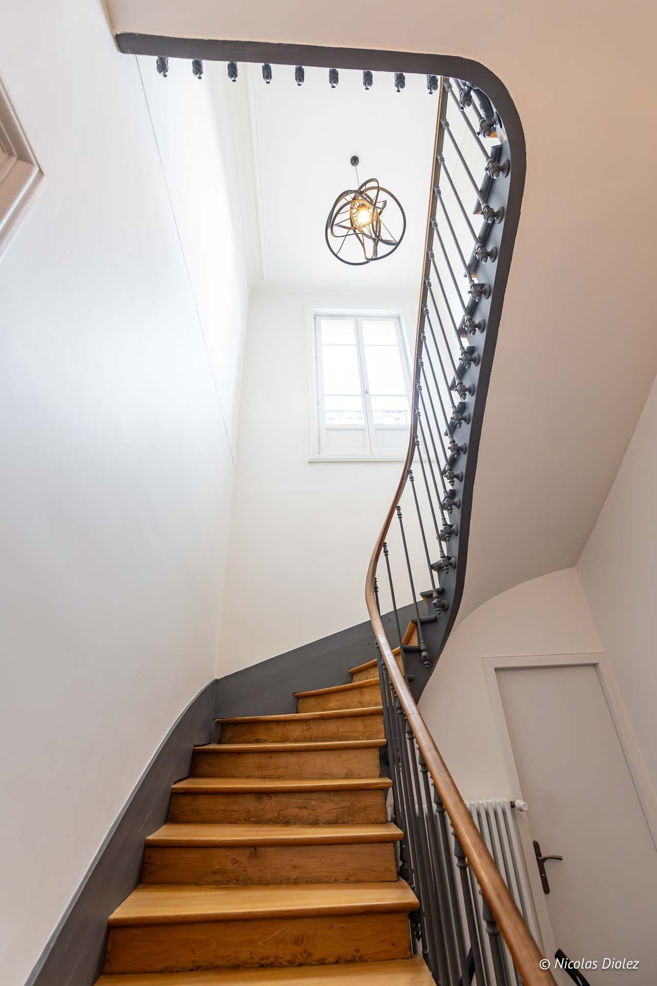 Elegant breakfast room Maison M Troyes with buffet and fireplace.