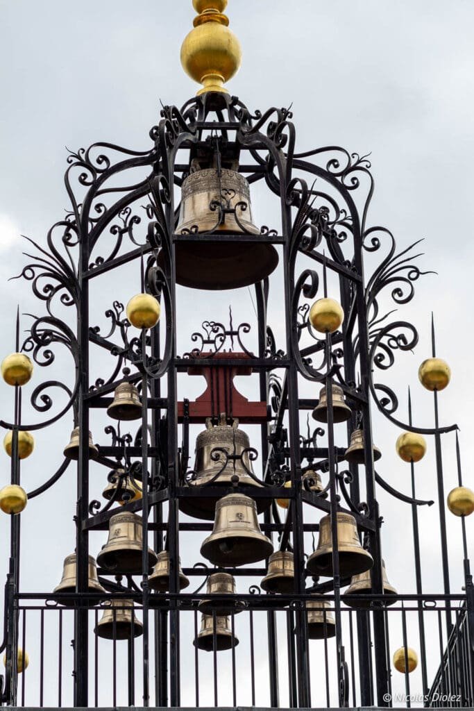 Bronze and gold bell carillon adorning the facade of Château Angélus, Saint-Émilion.