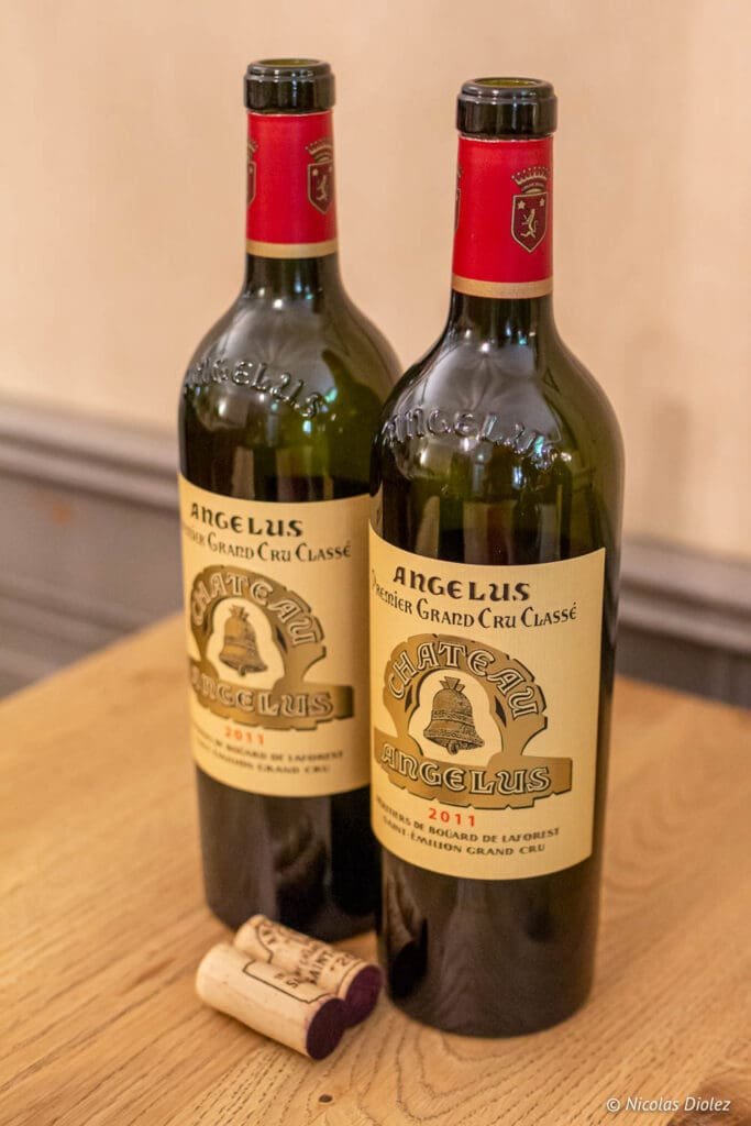 Two bottles of Château Angélus 2011 Saint-Émilion with corks.
