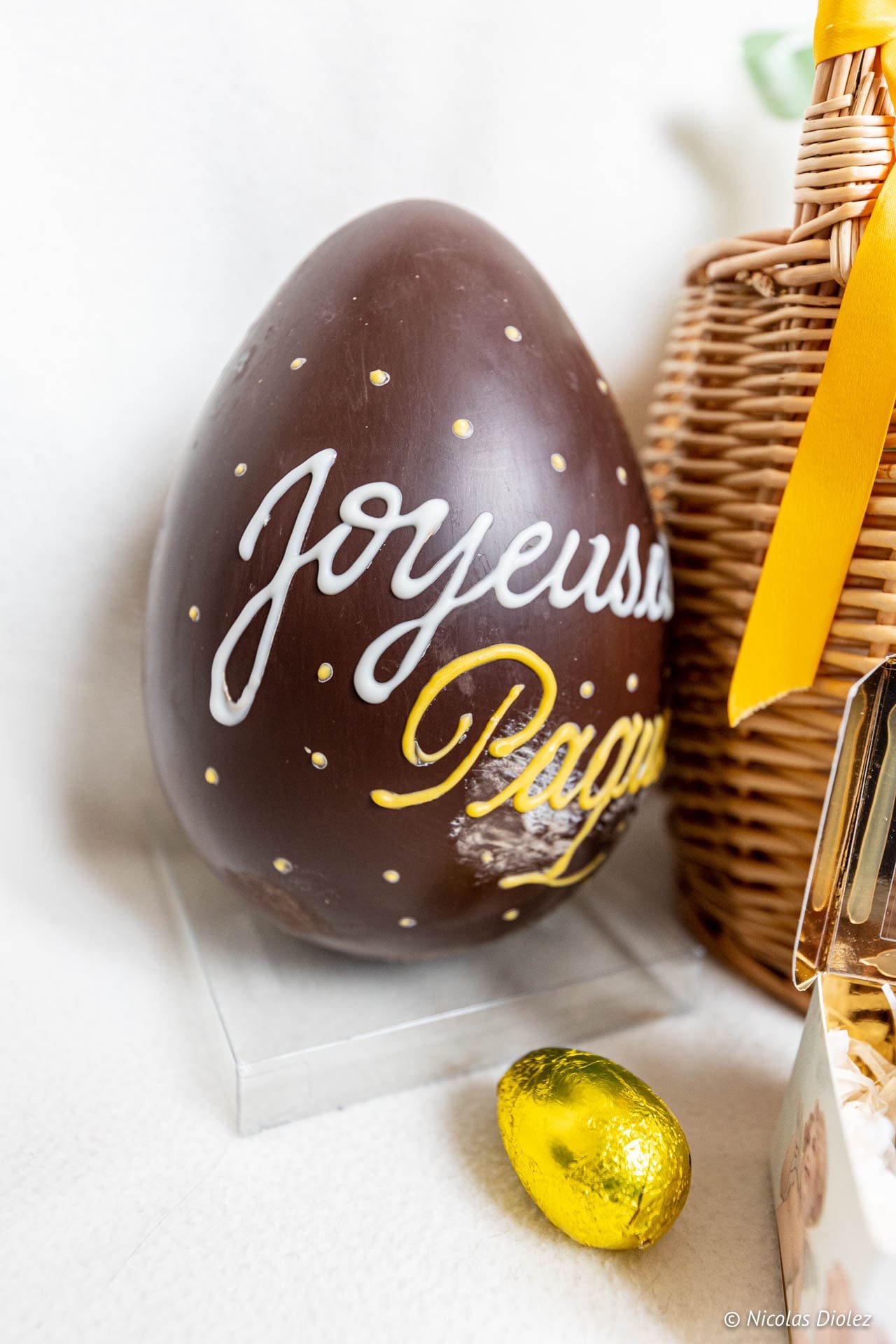 Happy Easter chocolate egg with wicker basket.