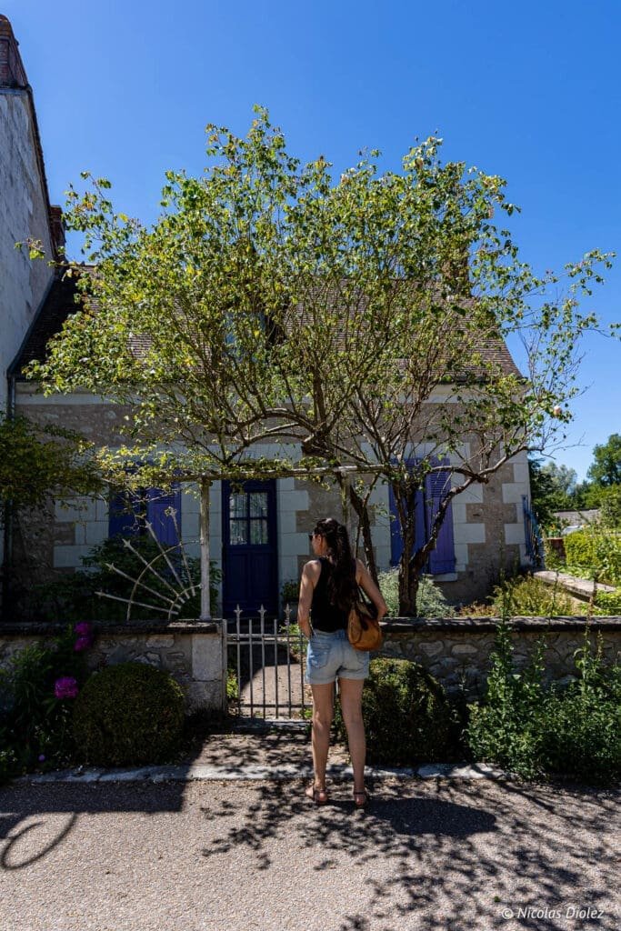 Woman in front of a typical Chédigny house, South Touraine.
