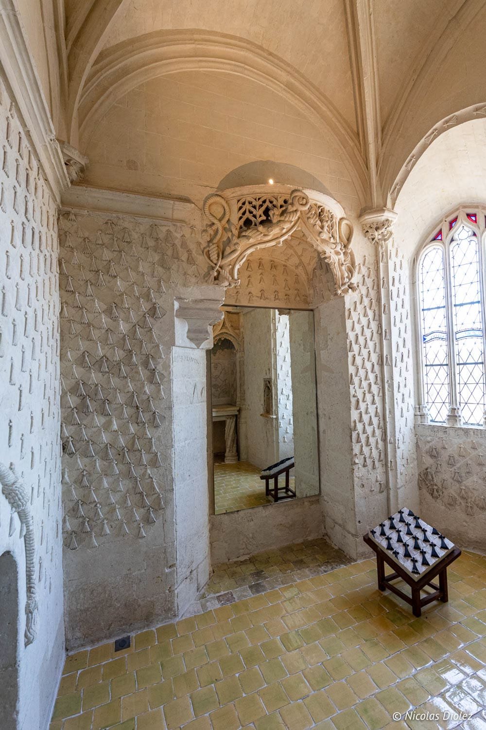 Intérieur Cité Royale de Loches avec murs à coquilles Saint-Jacques et vitrail.
