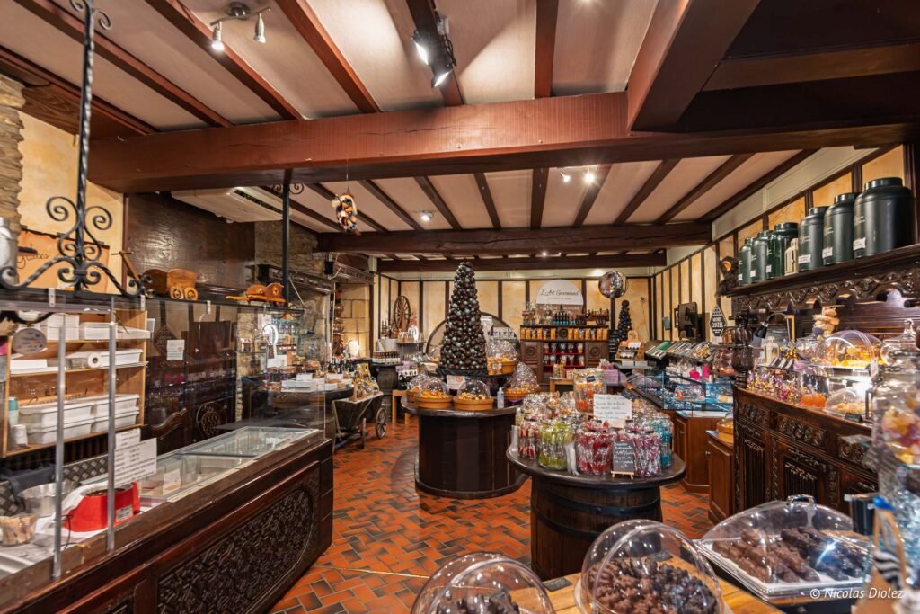 Intérieur boutique chocolaterie Rochefort-en-Terre avec présentoirs et décorations gourmandes.