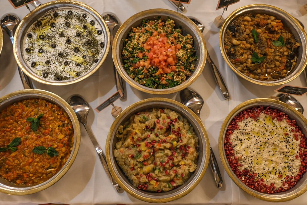 Assortment of traditional Lebanese mezzes served in metal bowls during a brunch at Noura restaurant.