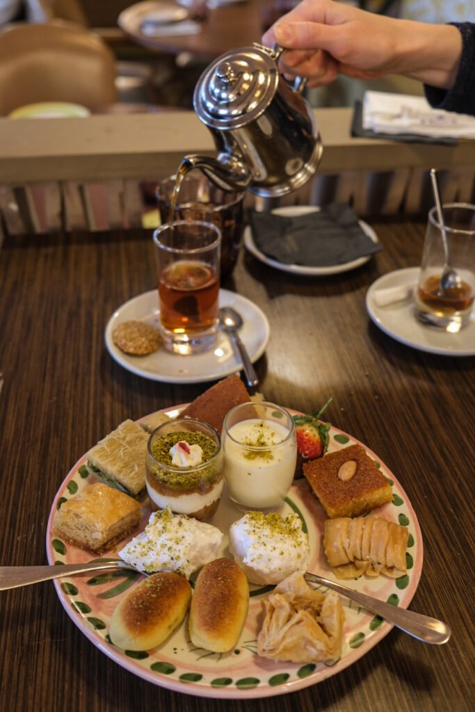 Mint tea service accompanied by an assortment of traditional Lebanese pastries at Noura Opéra restaurant.