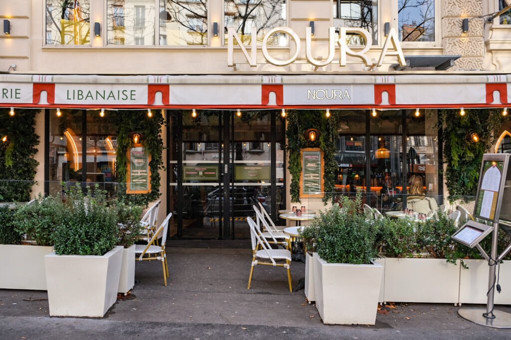 Facade of the Lebanese Noura restaurant with an outdoor terrace in Paris, offering brunch and catering services.