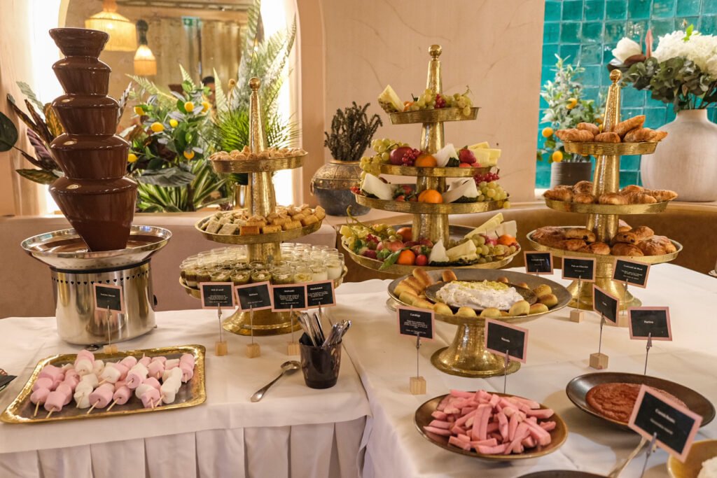 Refined brunch buffet at Noura Opéra restaurant with chocolate fountain, fresh fruit, viennoiseries, and Lebanese pastries.