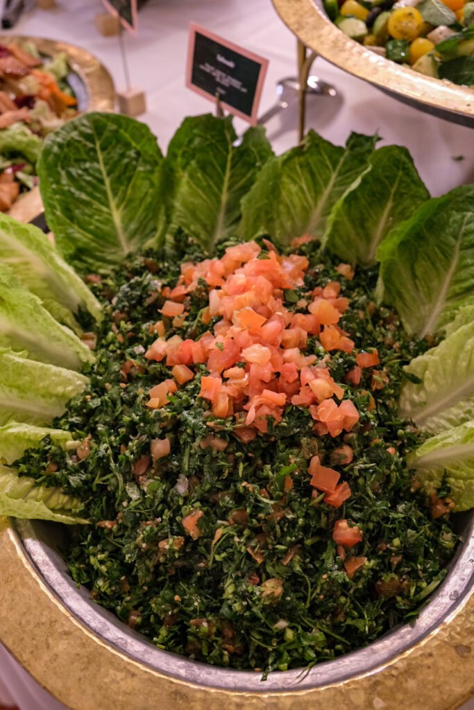 Fresh tabbouleh served in a dish during Noura Opéra brunch with crisp lettuce leaves.