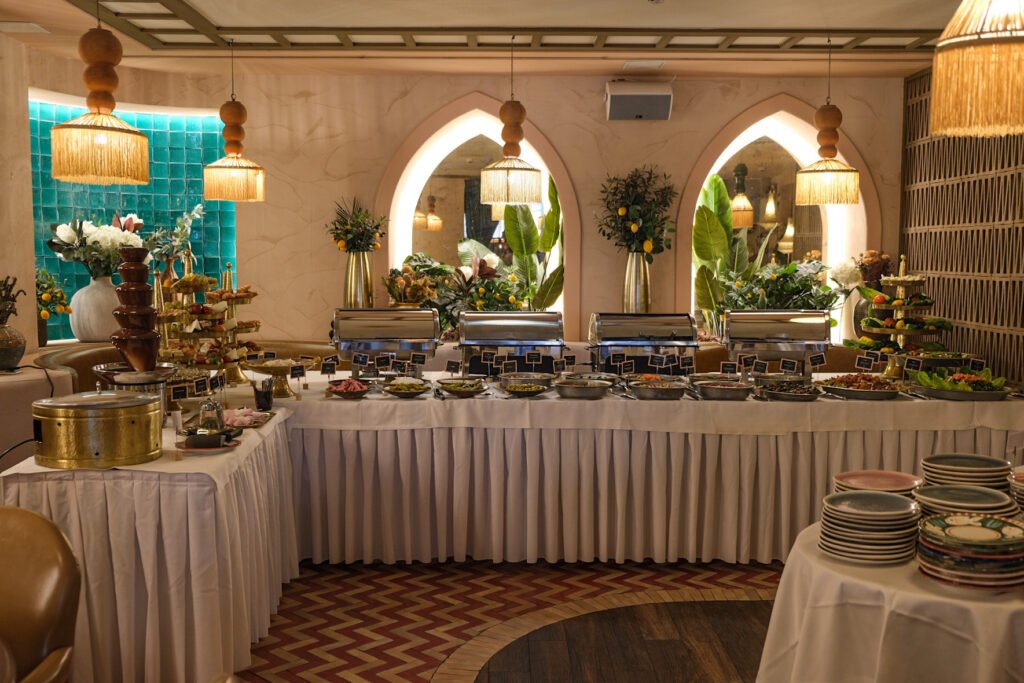 Brunch buffet at Noura Opéra restaurant with hot dishes, chocolate fountain, and selection of Lebanese dishes.