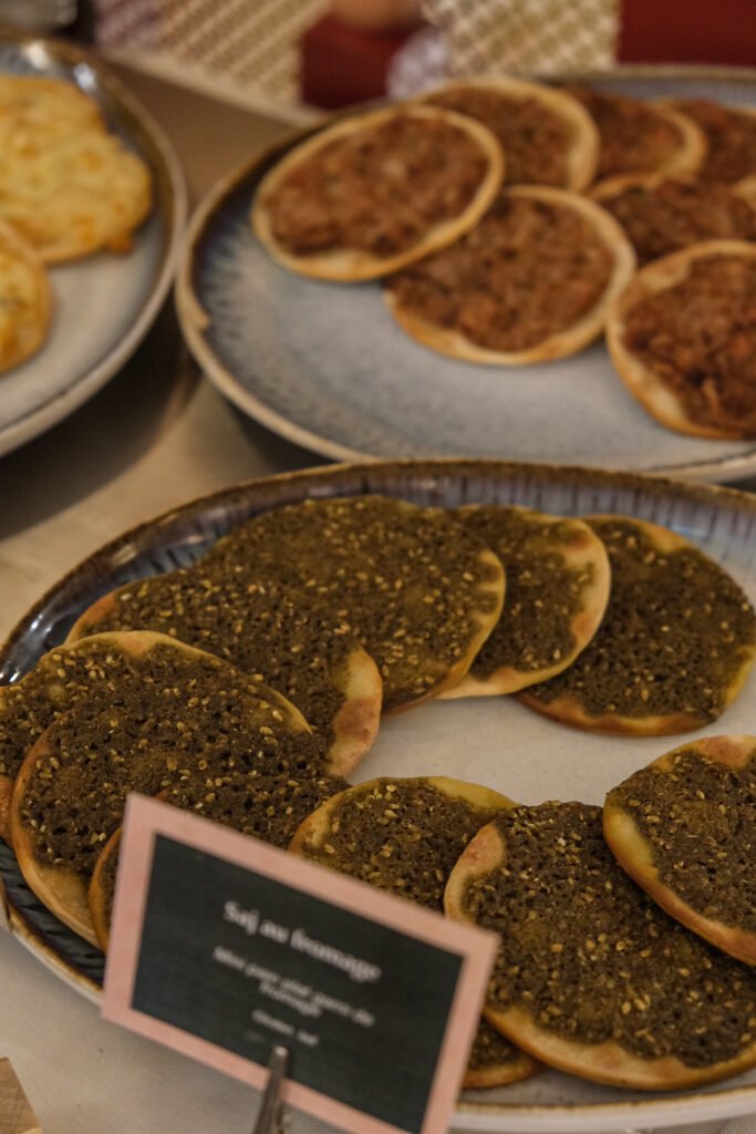 Assortment of manakish with zaatar and lahmajoun on a brunch buffet at Noura restaurant in Paris.