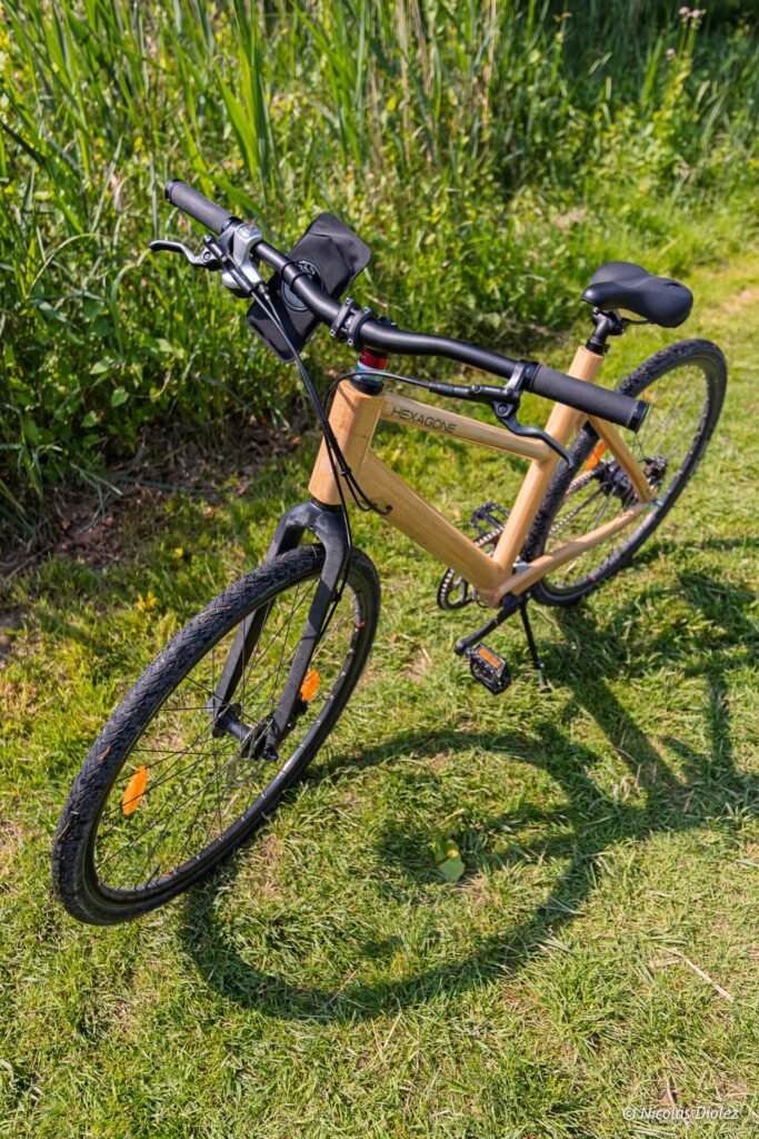Vélo Hexagone en bois stationné dans l'herbe à Châlons-en-Champagne.