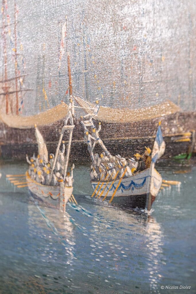 Peinture impressionniste représentant deux barques traditionnelles avec des rameurs dans le port de l'Espace Paul Valéry.
