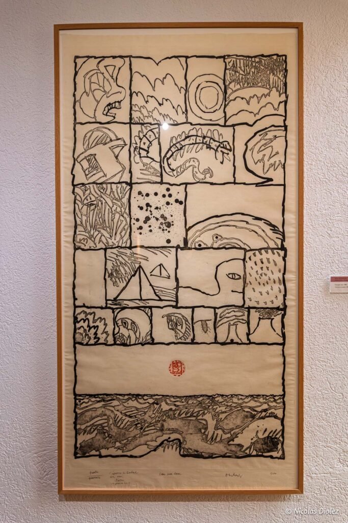 Gravure abstraite encadrée de Pierre Alechinsky exposée à l'Espace Paul Valéry, composée de cases dessinées à l'encre.