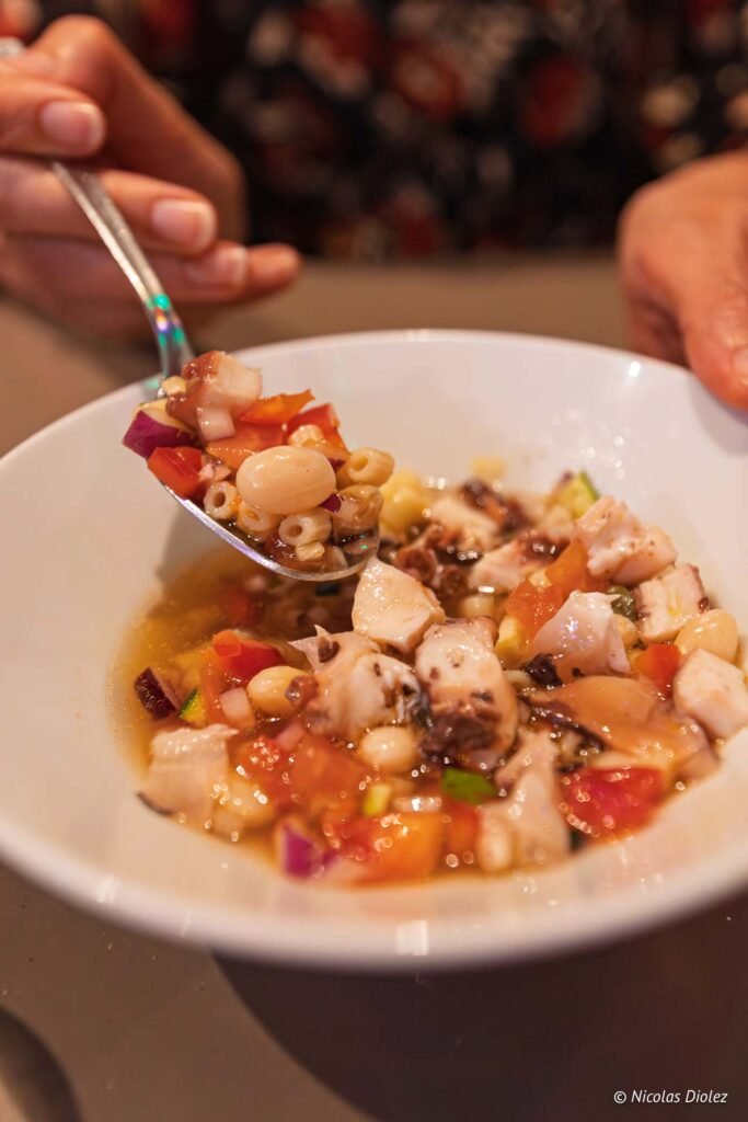 Salade de poulpe, légumes et petites pâtes servie dans un bol au restaurant Paris Méditerranée à Sète.