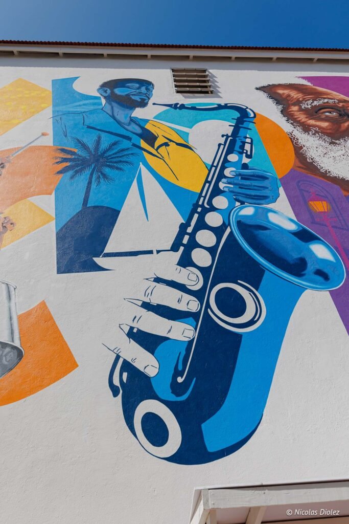 Fresque murale colorée représentant un saxophoniste et des symboles tropicaux dans la partie hollandaise de Saint-Martin.
