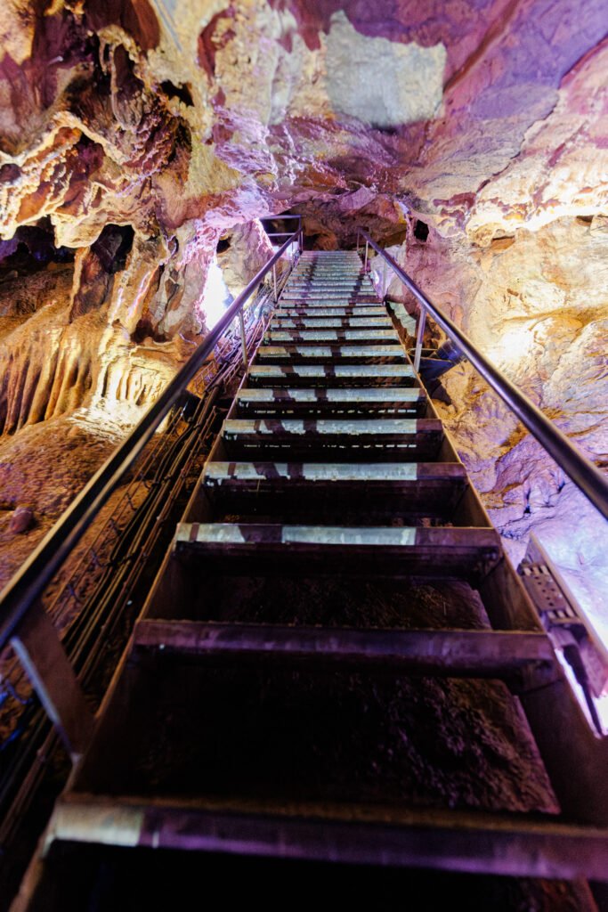 Metal staircase for touring the Saulges caves and their rock walls.